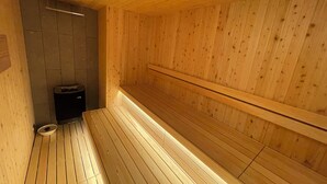 A sauna with wooden walls and benches. - Hotel Crystal Plaza (Hitachinaka)