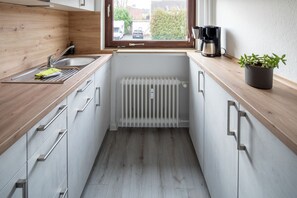 Fridge, stovetop, dishwasher, coffee/tea maker