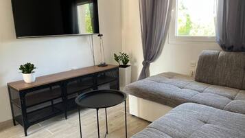 Apartment (One Bedroom Apartment with Balcony (2) | Living room | 32-inch flat-screen TV with satellite channels