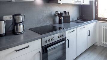 Fridge, stovetop, dishwasher, coffee/tea maker