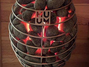 A spherical structure with a metallic frame and a glowing red interior, possibly a decorative piece or a light fixture.