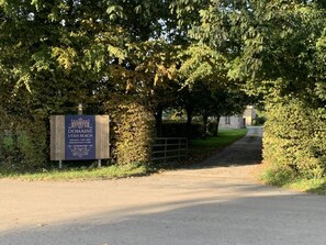 A sign for Domaine Utah Beach, indicating a property with a garden, a pool, and a restaurant.