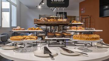 A buffet setup with various desserts and pastries displayed on multiple serving stands.