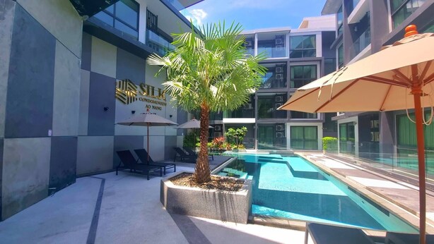 A modern building with a sign reading "Silk Condominium AO NANG". - B306 - 1 Bedroom Condo Pool View Near Ao Nang Beach (Krabi)