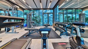 A modern gym with cardio equipment, weight machines, and dumbbells. - B306 - 1 Bedroom Condo Pool View Near Ao Nang Beach (Krabi)