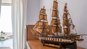 A model ship on a wooden table with a plaque reading "Constitution". - Italianway - Vele D'Amare (Imperia)
