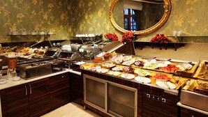 A buffet setup with various food items and a mirror above. - Nil Hotel Istanbul City Center (Istanbul)