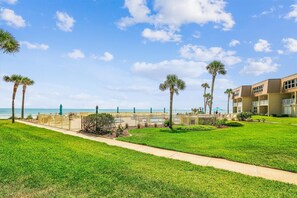 A hotel with a pool area, palm trees, and a view of the ocean. - New! Summer Deal: Free Fun and Beach Gear Credit (St. Augustine)