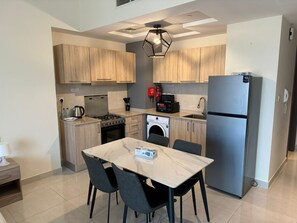Enjoy cooking in this well-equipped kitchen with an oven, compact dishwasher, and stainless steel appliances.