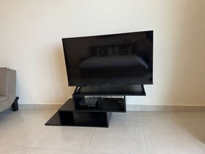 Relax in this stylish living room with a flat-screen TV and entertainment center.