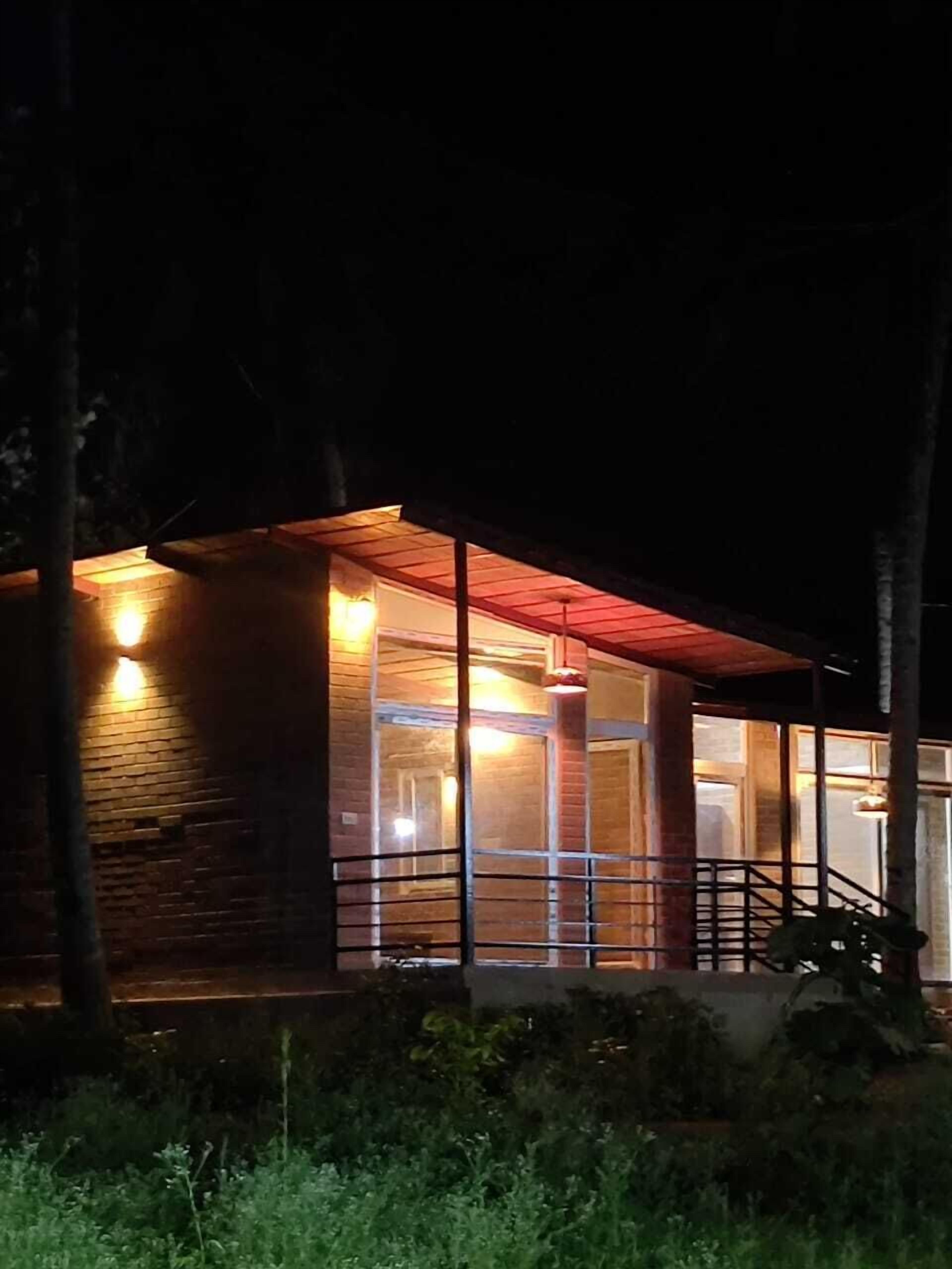 A modern building with large windows and a wooden exterior.