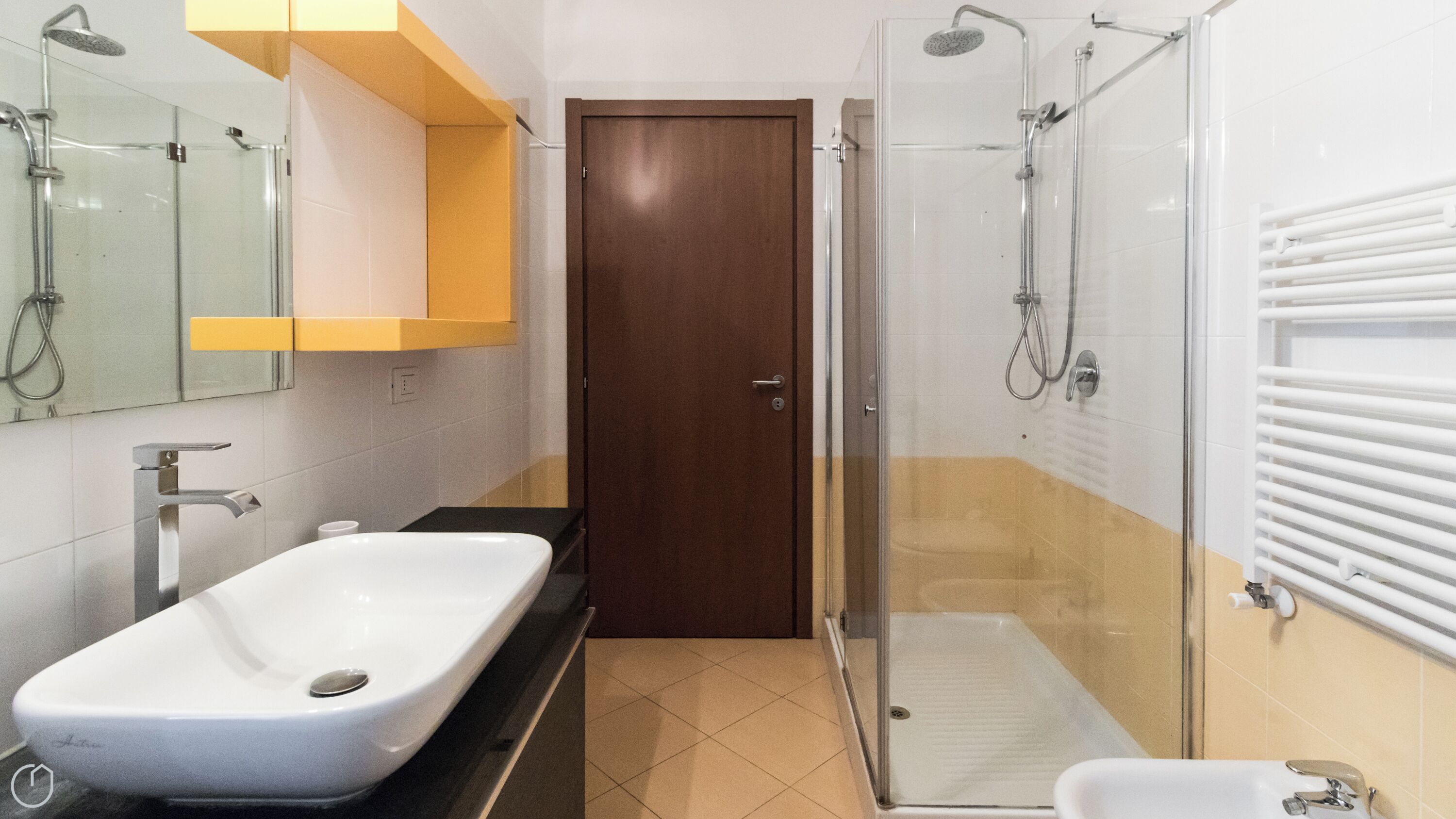 Ein modernes Badezimmer mit einem großzügigen Waschbecken, einer Duschkabine aus Glas und einem WC.