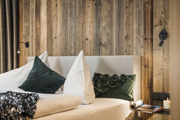 Relax in a serene bedroom with a neutral-toned bed, adorned with pillows and a bedside table.