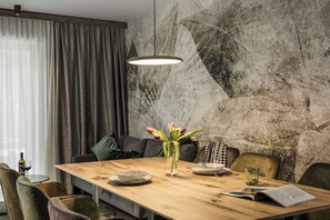 Enjoy a meal for two at this stylish dining area, complete with a beautifully set table and comfortable seating.