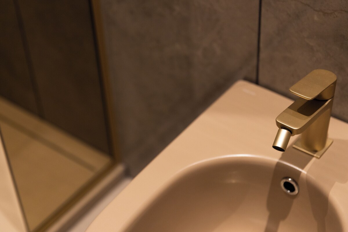 A bathroom sink with a modern faucet and a mirror.