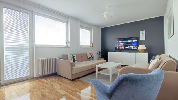 A modern living room with a sofa, a coffee table, and a TV. - One bedroom apartment with panoramic view of Zagreb (Zagreb)