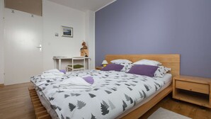 A bedroom with a bed, a desk, a chair, a nightstand, and a wall-mounted shelf. - One bedroom apartment with panoramic view of Zagreb (Zagreb)