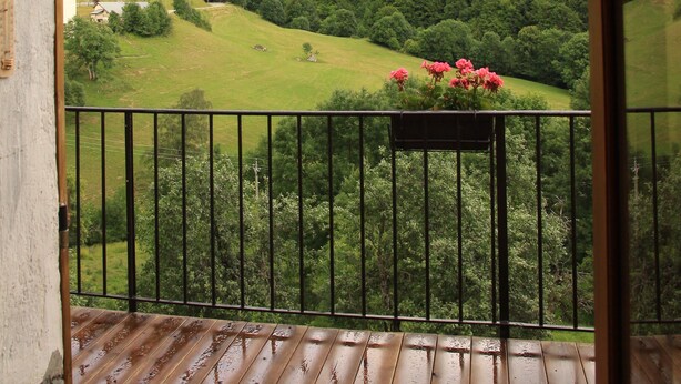 A balcony with a view of a mountainous landscape.