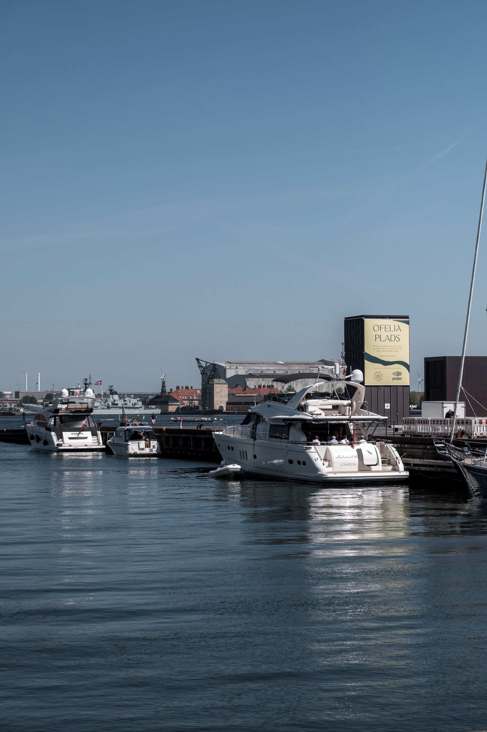 A marina with several yachts docked.