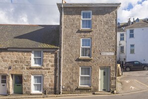 A stone building with multiple windows and a sign reading "UMFULA PLACE".