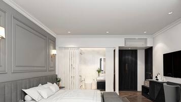 A modern bedroom with a large bed, a bedside table, a mirror, a dark wardrobe, and a bathroom visible through an open door.