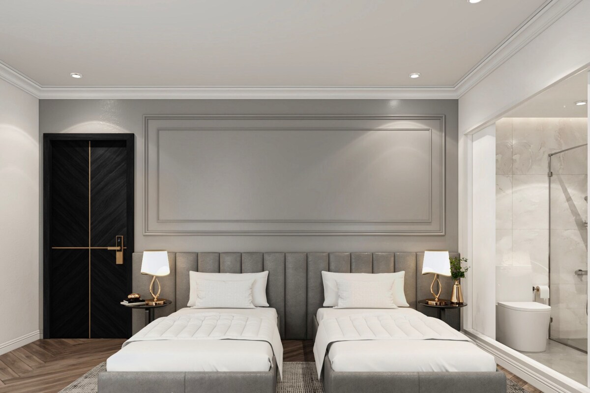 A modern hotel room with two beds, a large mirror, a walk-in closet, and a bathroom with a shower.