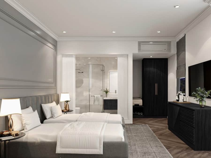 A modern bedroom with a large bed, bedside tables, a walk-in closet, and a bathroom with a shower.