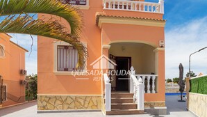 A two-story building with a stone base and a balcony. - Villa La Zenia close to Beach, private pool, walking distance of Zenia Boulevard (Orihuela)