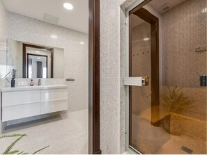 A modern bathroom with a glass shower enclosure, a white vanity with a mirror, and a tiled backsplash. - Luxury Holiday Villa El Paraiso Alto, Benahavis, Marbella 10 bedrooms (Benahavis)