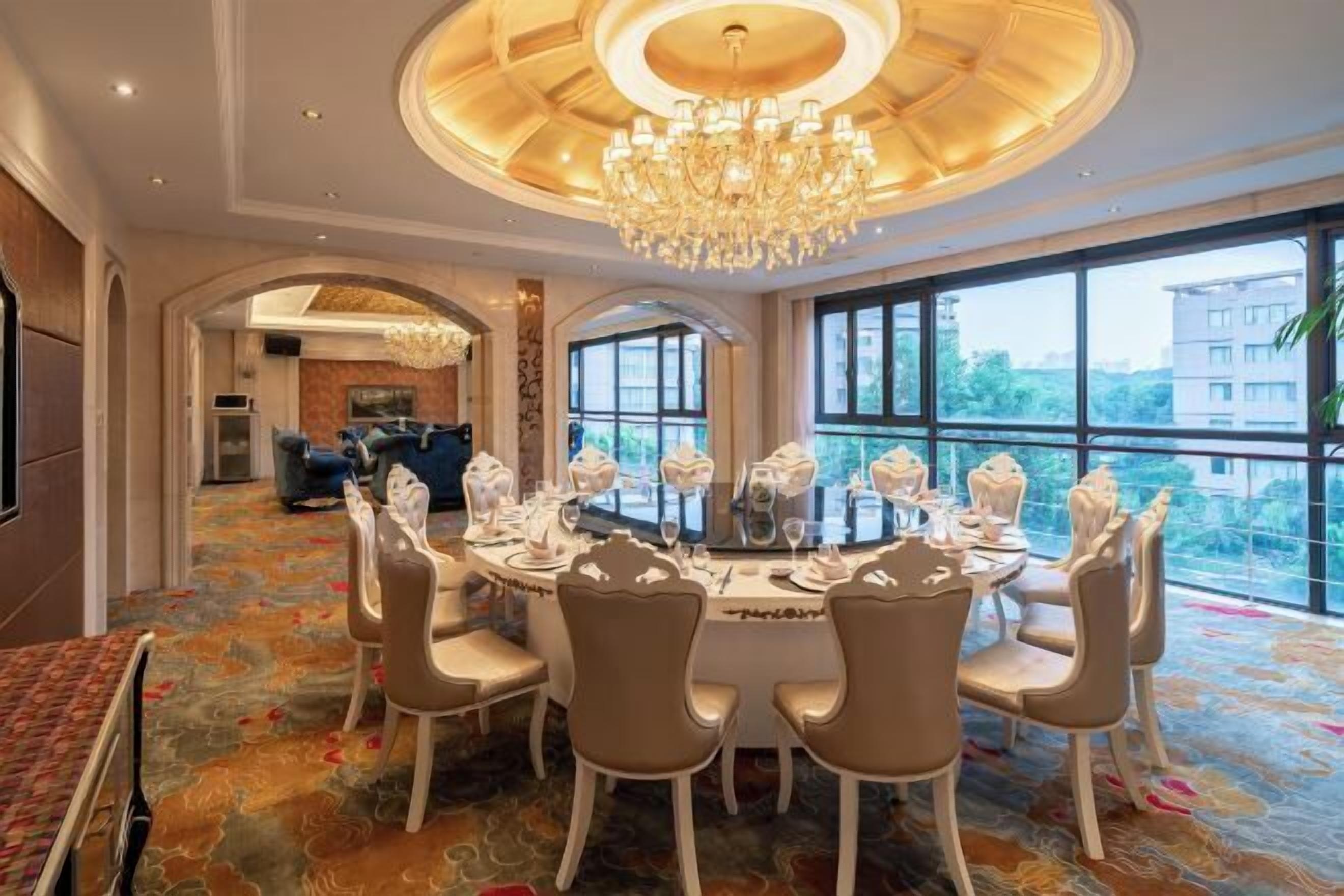 A dining area with a round table set for six, surrounded by six chairs.
