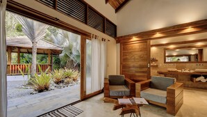 Un intérieur moderne avec un plancher en bois, un canapé, un fauteuil et une petite table.