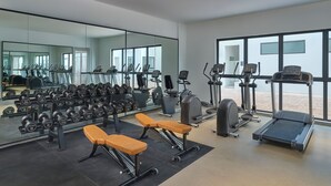 A modern gym with various equipment, including treadmills, dumbbells, and benches. - Fairfield By Marriott Kuala Besut (Kampong Raja)