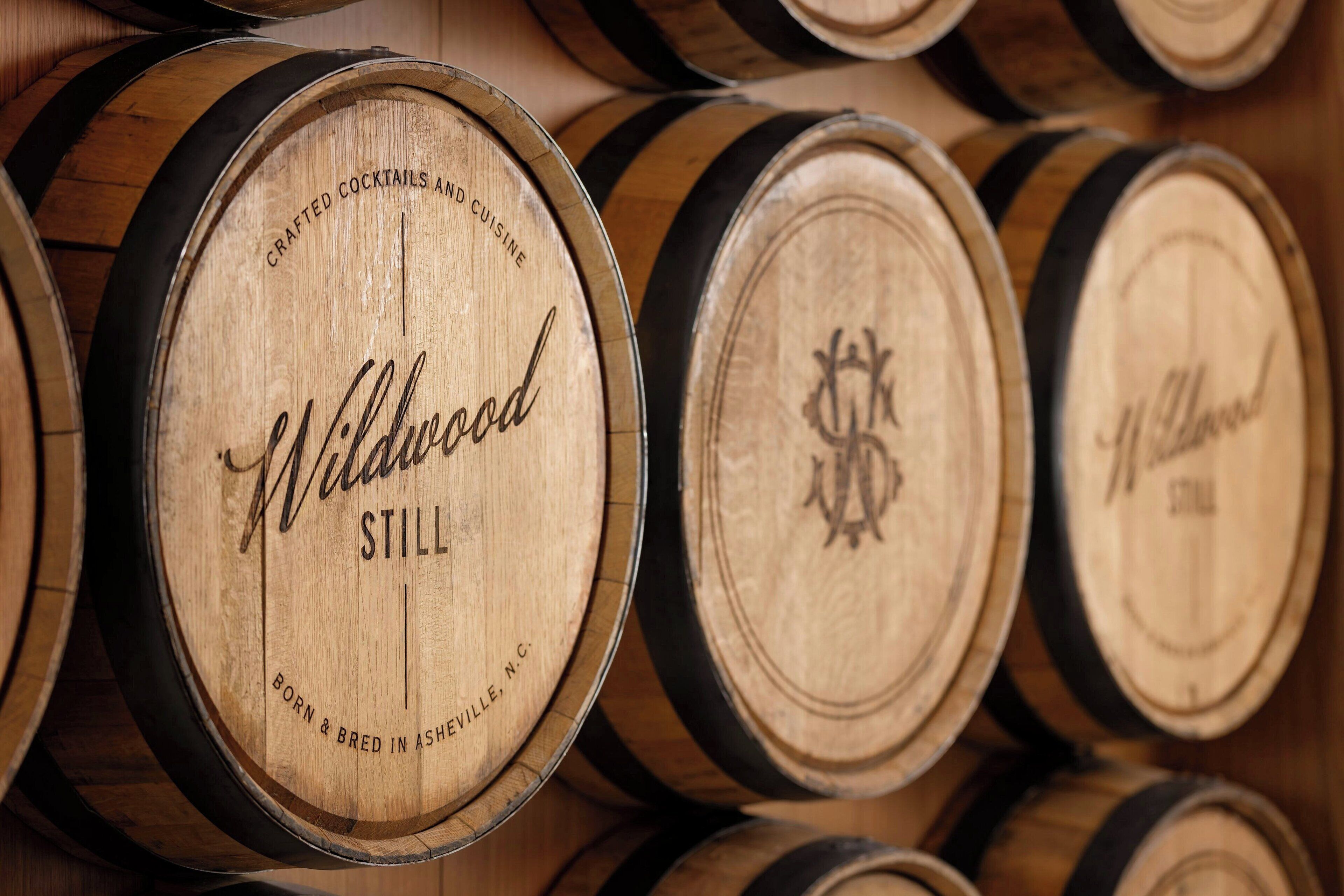 Wooden barrels stacked in a warehouse.