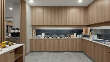 A modern kitchen with wooden cabinets, a tiled backsplash, and a breakfast bar.