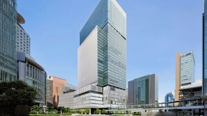 A modern high-rise building with a glass facade, surrounded by other contemporary structures. - THE OSAKA STATION HOTEL, Autograph Collection (Osaka)