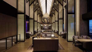 A modern hotel lobby with a central seating area, high ceilings with geometric patterns, and a view of the cityscape. - THE OSAKA STATION HOTEL, Autograph Collection (Osaka)