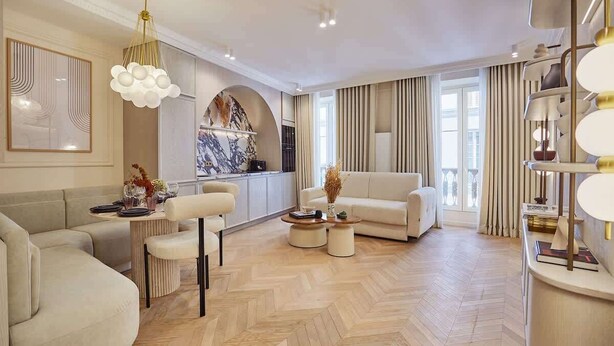A spacious living room with a herringbone floor, a sofa set, a coffee table, and a chandelier. - Apartment in the Marais with Air-conditioned (Paris)