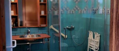 A bathroom with a shower, a sink, and a toilet.