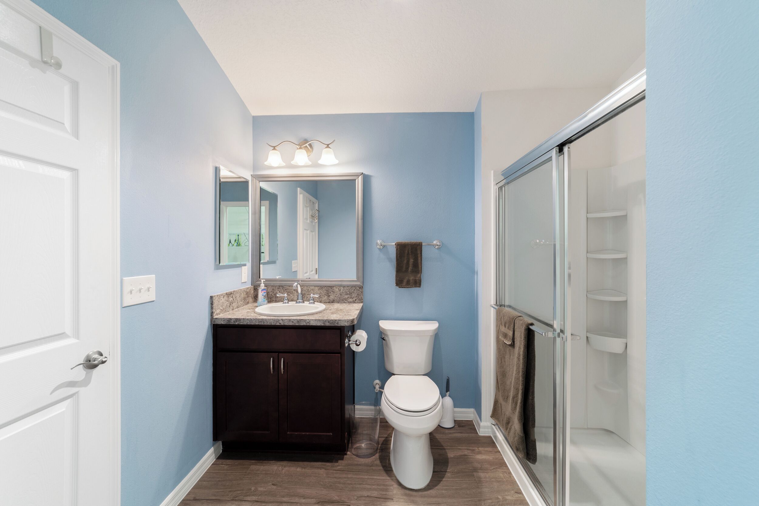 A bathroom with a sink, toilet, and shower.