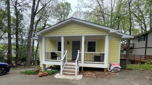 A small, single-story house with a front porch and a covered driveway. - Newly Renovated Lakefront Home with Kayaks and Paddleboards (Locust Grove)