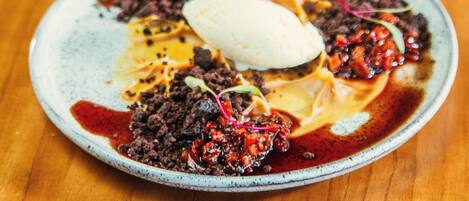 A plate of food with a scoop of ice cream on top.