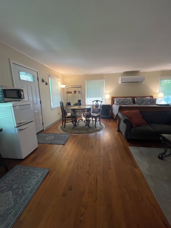 A compact living space with a kitchenette, dining area, and seating area.