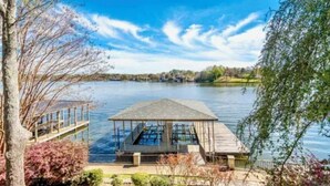 A lakeside gazebo with a wooden deck and a glass bottom pool. - Beautiful, Private Lake House with Double Dock (Hot Springs)