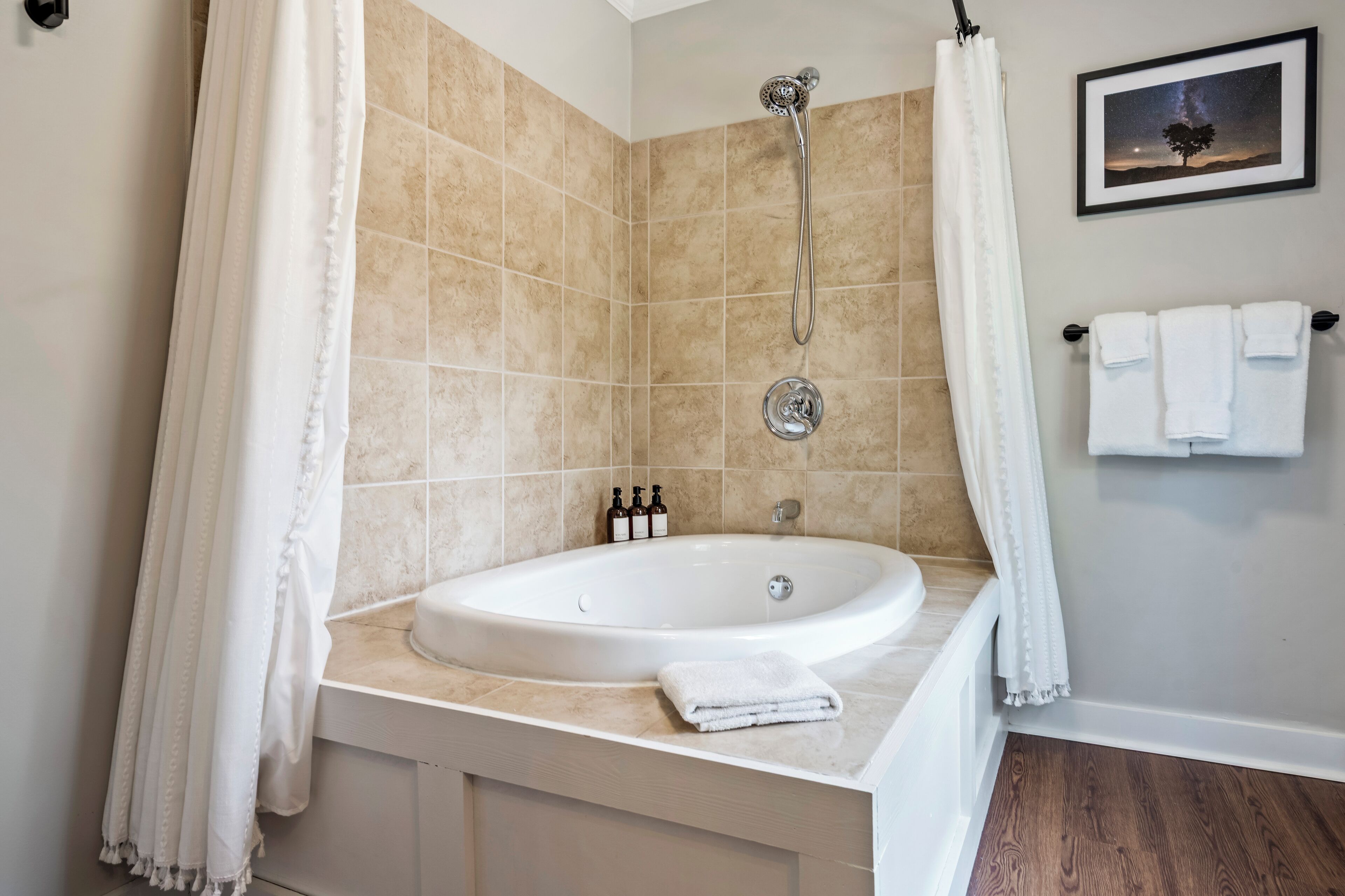 Un baño con bañera, ducha y un perchero para toallas.