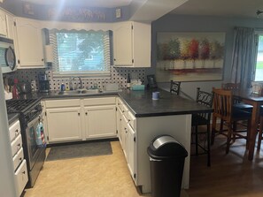 Fridge, microwave, oven, stovetop - Cozy bungalow in Marquette w/ hot tub. Minutes from Lake Superior and downtown. (Marquette)
