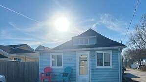 A small, single-story house with a front porch, two Adirondack chairs, and a mailbox. - Little Blue on Second St! Cozy & close to the beach, pub, bar, and downtown! (Port Stanley)