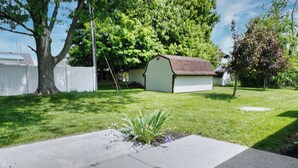 A residential backyard with a shed, a tree, and a lawn. - Spacious Home Near WEC, The Roberts Center and Wilmington College (Wilmington)