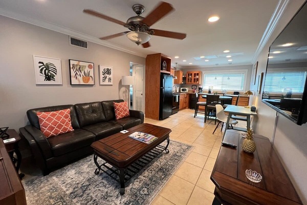 Open plan Living room with dedicated work space and 55 inch Roku smart TV.