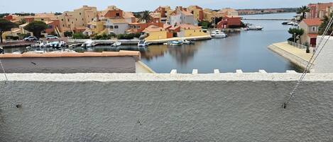 A hot tub with a view of a marina and buildings.