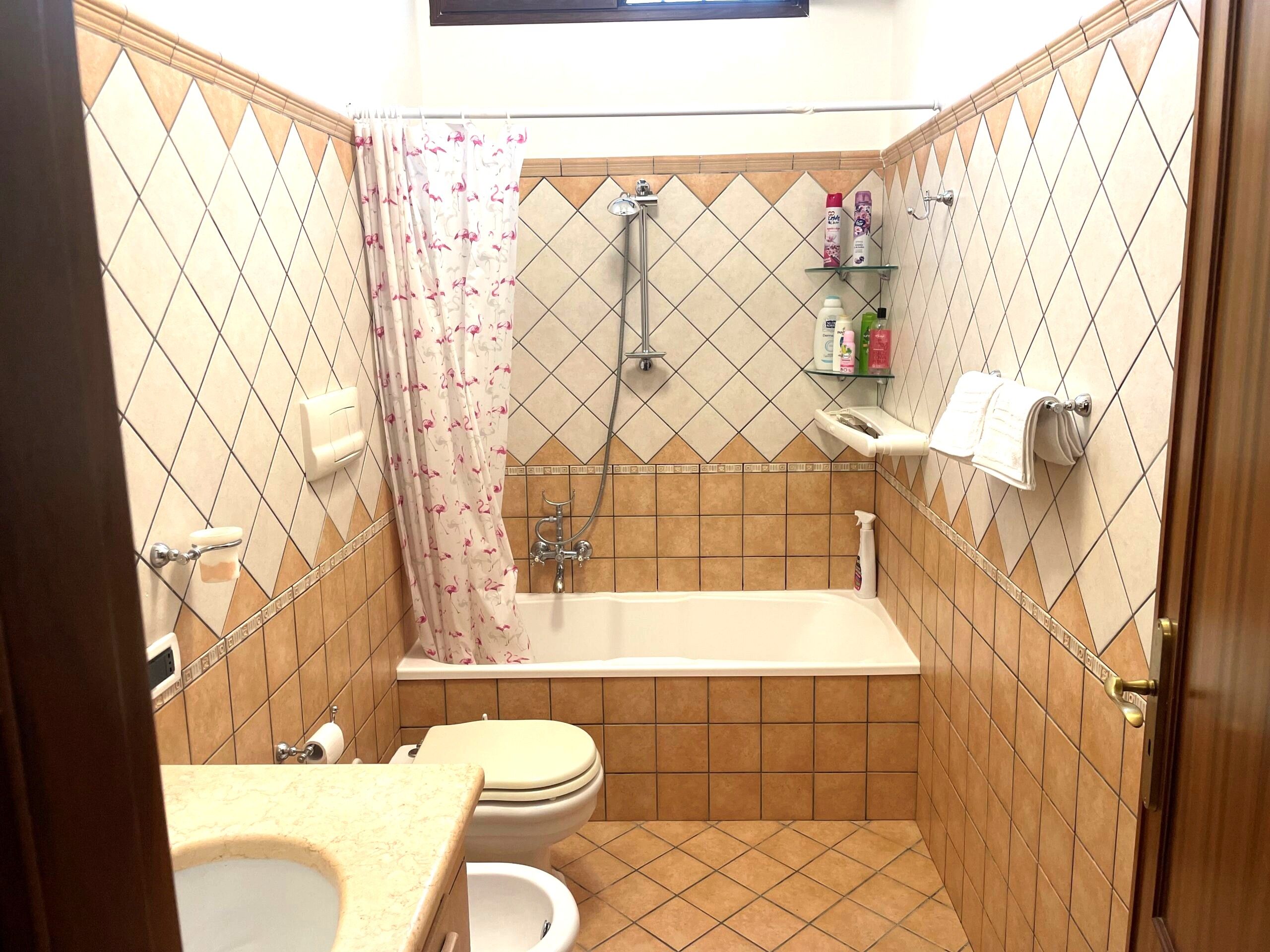 A bathroom with a bathtub, toilet, and shower.